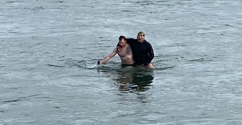 Brian Gibson rescues a man from the river.