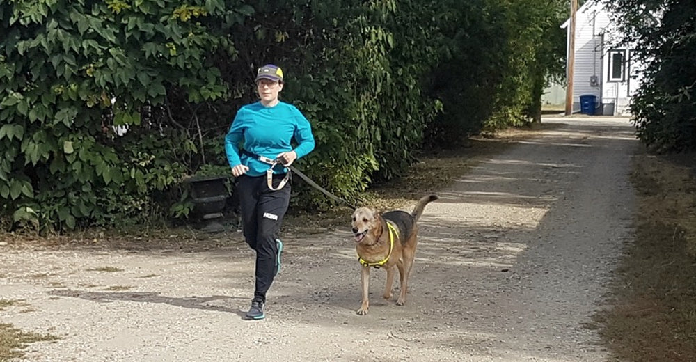 Lisette Schermann runs with her dog, Troy.
