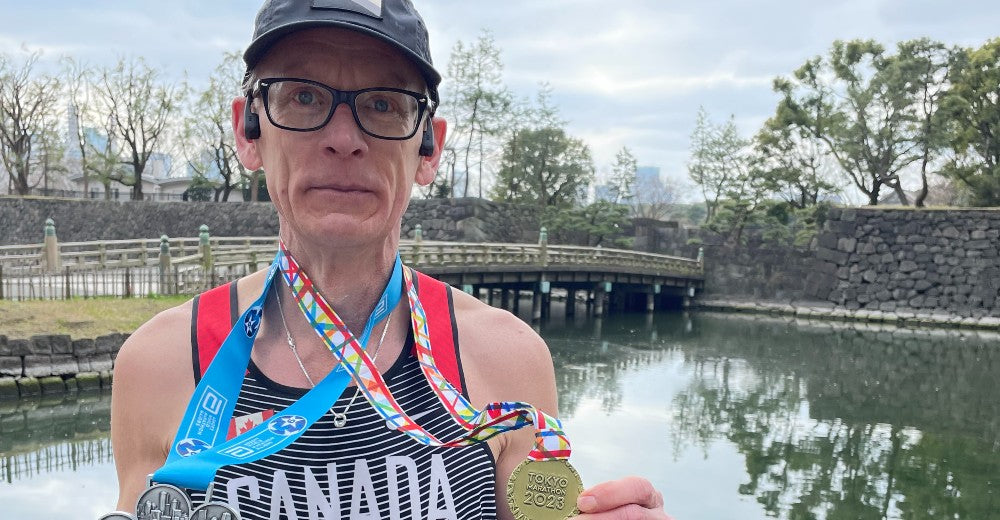 Pat Somerville shows off his medals after completing the 2023 Tokyo Marathon.