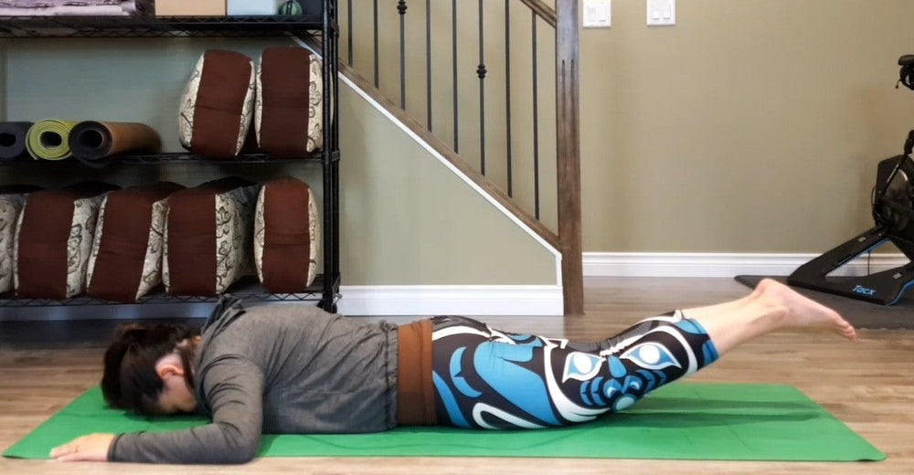 Jackie Lai demonstrates the locust pose.